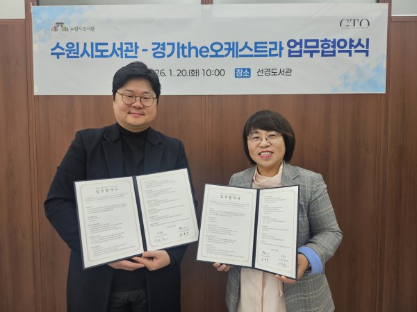 최현주 수원시도서관사업소장(오른쪽)과 허석환 경기더(the)오케스트라 관계자가 협약 후 기념촬영을 하고 있다. 